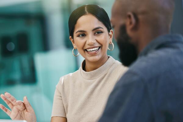  A joyful black woman conversing with another black man